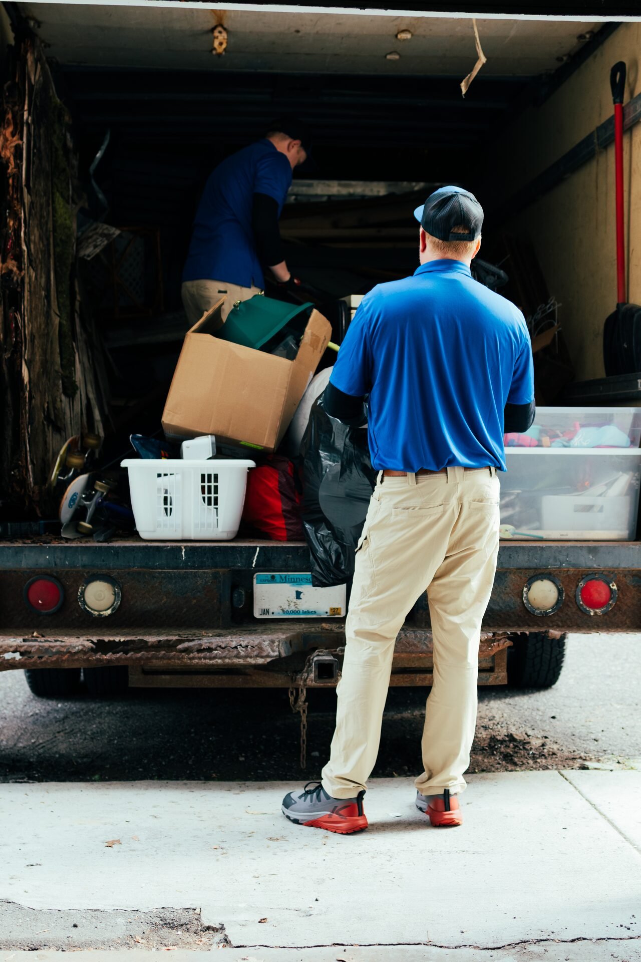 AP Brothers crew loading a box truck on a junk removal job